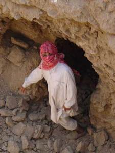 A looter points to where he found an object on an archaeological site in southern Iraq in 2003.