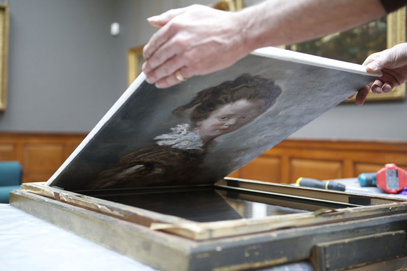 The replica is removed from the original frame in preparation for the big reveal last week
