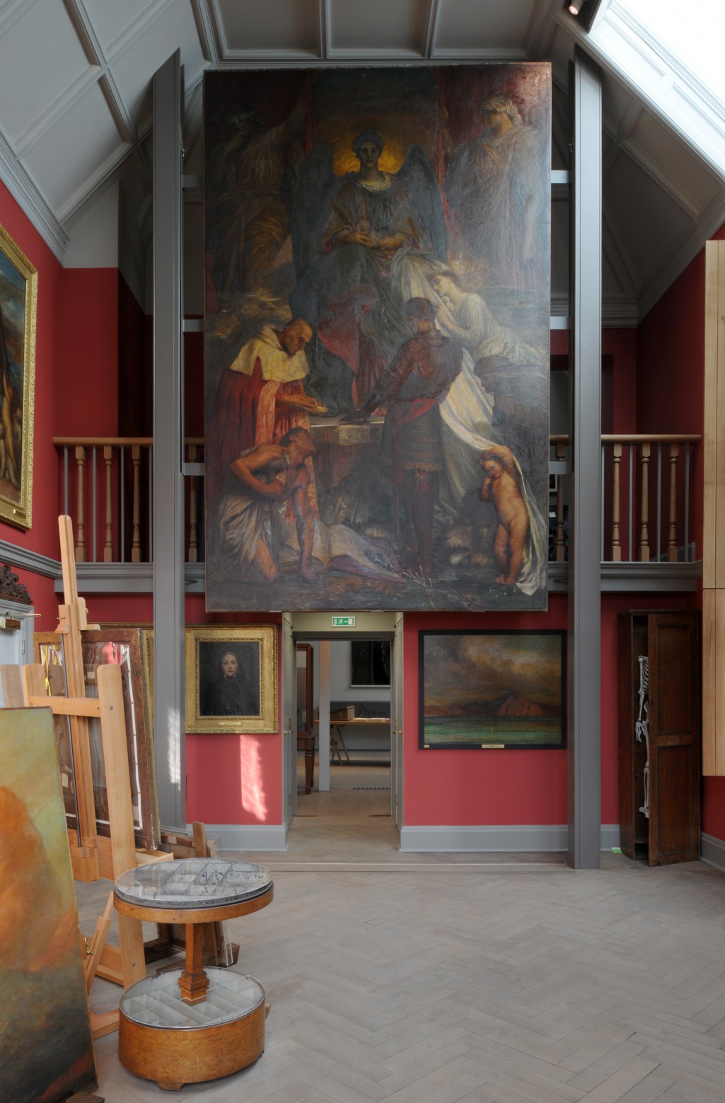G.F. Watts’s The Court of Death (c. 1879–1902) hangs in the studio above a slot in the floor leading to the room below