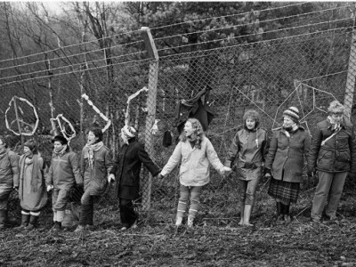 'Embrace the Base’: 30,000 women link hands, completely surrounding the nine mile perimeter fence at RAF/USAF Greenham Common, Berkshire (1982), Edward Barber.
