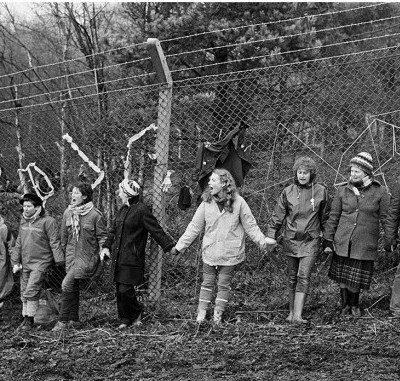 'Embrace the Base’: 30,000 women link hands, completely surrounding the nine mile perimeter fence at RAF/USAF Greenham Common, Berkshire (1982), Edward Barber.
