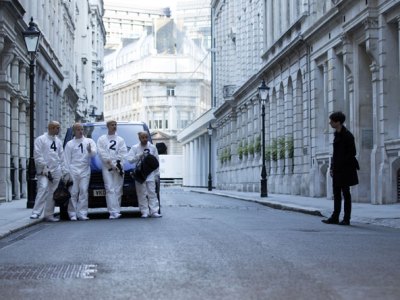Remainder (2016), Omer Fast. Tom (Tom Sturridge) peers round model of Madlyn Mansions