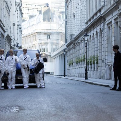 Remainder (2016), Omer Fast. Tom (Tom Sturridge) peers round model of Madlyn Mansions