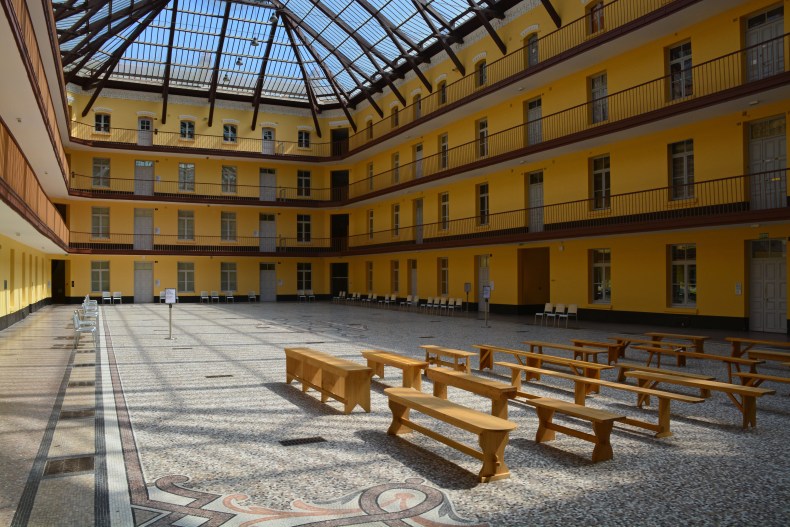 The central living block at Le Familistère de Guise. The furniture in the foreground is part of Francis Cape's 'Utopian Benches' exhibition. 