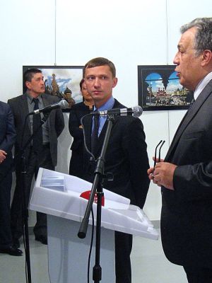 Andrei Karlov (R), the Russian ambassador to Ankara, gives a speech before being shot by a gunman (unseen) during an art exhibition in Ankara. Photo: UGUR KAVAS/AFP/Getty Images