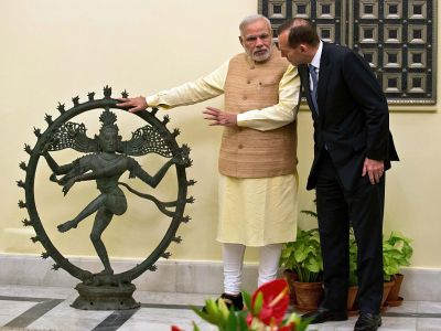 Indian Prime Minister Narendra Modi and Australian Prime Minister Tony Abbott talk alongside a statue of the Dancing Shiva ahead of a meeting in New Delhi, 5 September, 2014. The $5 million bronze statue was returned to India from the National Gallery of Australia after it emerged that it had been stolen from a Tamil Nadu temple. PRAKASH SINGH/AFP/Getty Images)