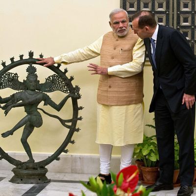 Indian Prime Minister Narendra Modi and Australian Prime Minister Tony Abbott talk alongside a statue of the Dancing Shiva ahead of a meeting in New Delhi, 5 September, 2014. The $5 million bronze statue was returned to India from the National Gallery of Australia after it emerged that it had been stolen from a Tamil Nadu temple. PRAKASH SINGH/AFP/Getty Images)