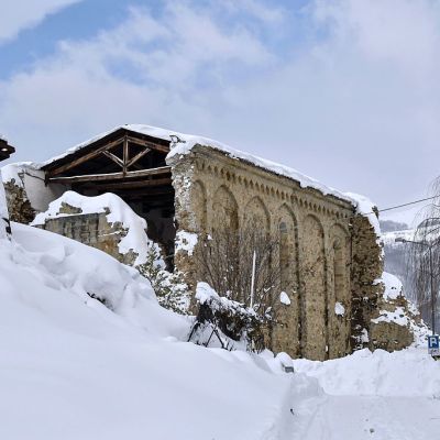 Italian military vehicles stand guard in front a Sant'Agostino church in Amatrice on January 19, 2017 after a 5.7-magnitude earthquake struck the region. The church was severely damaged in a major quake in August 2016. ANDREAS SOLARO/AFP/Getty Images
