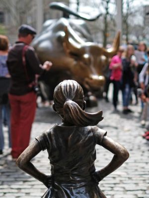 The Fearless Girl (front) statue stands facing the 'Charging Bull' as tourists take pictures in New York on 12 April, 2017. JEWEL SAMAD/AFP/Getty Images