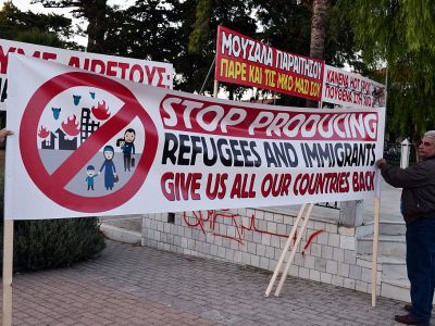 Chios residents arrange banners during an anti-migrant demo on the island of Chios on 28 September, 2016. Irish photographer Richard Mosse claims he was arrested while observing a similar rally on the island last week. Photo: LOUISA GOULIAMAKI/AFP/Getty Images