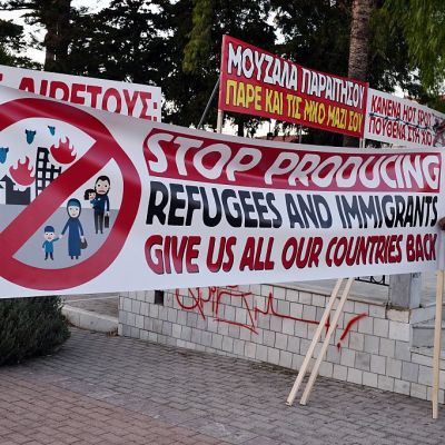 Chios residents arrange banners during an anti-migrant demo on the island of Chios on 28 September, 2016. Irish photographer Richard Mosse claims he was arrested while observing a similar rally on the island last week. Photo: LOUISA GOULIAMAKI/AFP/Getty Images