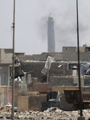 A general view shows smoke rising near the leaning Al-Hadba minaret in the Al-Nuri mosque compound, as Iraqi government forces advance in western Mosul's Zanjili neighbourhood on 7 June, 2017, during ongoing battles against Islamic State (IS) group fighters. Photo: KARIM SAHIB/AFP/Getty Images