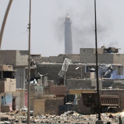 A general view shows smoke rising near the leaning Al-Hadba minaret in the Al-Nuri mosque compound, as Iraqi government forces advance in western Mosul's Zanjili neighbourhood on 7 June, 2017, during ongoing battles against Islamic State (IS) group fighters. Photo: KARIM SAHIB/AFP/Getty Images