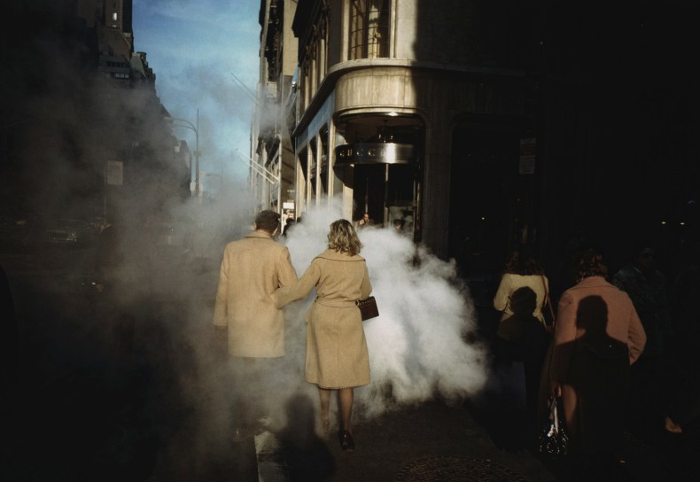 Camel Coat Couple in Street Steam, New York City, 1975, Joel Meyerowitz. Courtesy of the artist and Howard Greenberg Gallery.