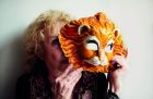 Carolee Schneemann holding a Venetian lion mask, photographed in London in May 2017, Photo: Benjamin McMahon