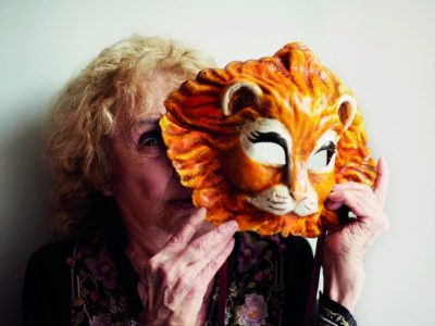 Carolee Schneemann holding a Venetian lion mask, photographed in London in May 2017, Photo: Benjamin McMahon