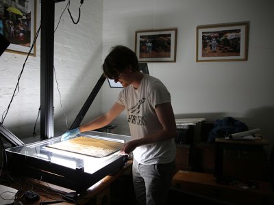 British Museum assistant collections manager Jonny Mortemore using the glass plate negative scanner. Courtesy of the Trustees of the British Museum