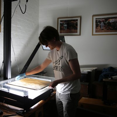 British Museum assistant collections manager Jonny Mortemore using the glass plate negative scanner. Courtesy of the Trustees of the British Museum