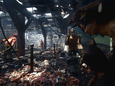 Indonesian firefighters working to extinguish a fire inside the 17th-century Dutch colonial building maritime museum in Jakarta on 16 January 2018.