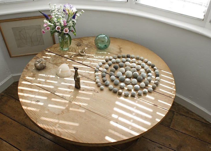 Installation view showing Jim Ede's placement of objects at Kettle's Yard, in which Henri Gaudier-Brzeska's Toy (1914) sits alongside Spiral of Stones (c. 1958)