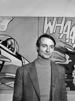 Roy Lichtenstein in front of one of his paintings at the Tate Gallery, London.