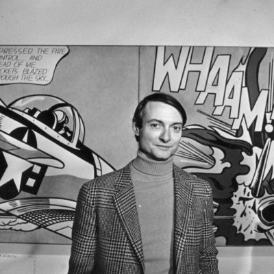 Roy Lichtenstein in front of one of his paintings at the Tate Gallery, London.