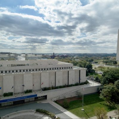 The Smithsonian's National Museum of American History, Kenneth E. Behring Center in Washington, D.C., with the Washington Monument and National Mall in the background.