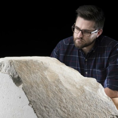 Daniel Potter, assistant curator at National Museum of Scotland, with a casing stone from the Great Pyramid of Giza.
