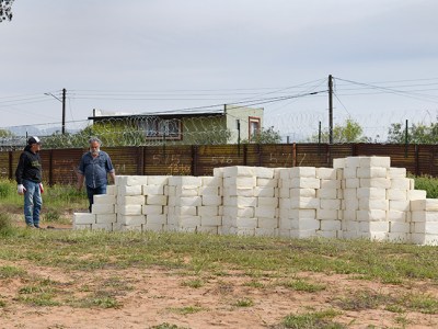 Artist Cosimo Cavallaro building his wall of cheese.
