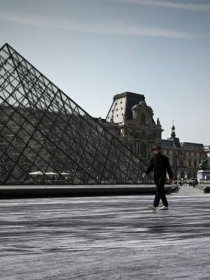Jean Rene, aka JR walks in the Cour Napoleon of the Louvre Museum as part of the 30th anniversary celebrations of the Louvre Pyramid, Photo: Philippe Lopez/AFP/Getty Images