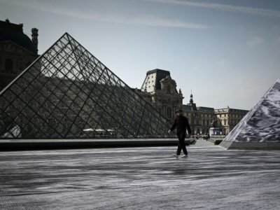 Jean Rene, aka JR walks in the Cour Napoleon of the Louvre Museum as part of the 30th anniversary celebrations of the Louvre Pyramid, Photo: Philippe Lopez/AFP/Getty Images
