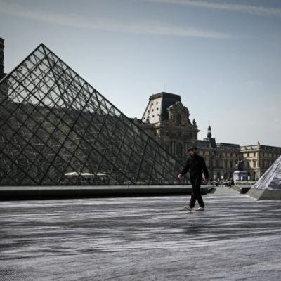 Jean Rene, aka JR walks in the Cour Napoleon of the Louvre Museum as part of the 30th anniversary celebrations of the Louvre Pyramid, Photo: Philippe Lopez/AFP/Getty Images
