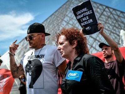 Nan Goldin at a P.A.I.N. protest in front of the Louvre in July 2019.