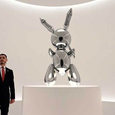 A security guard stands next to Jeff Koons‘ Rabbit (number two from an edition of three, plus one artist’s proof; 1986) at Christie’s New York in May 2019, ahead of its record-breaking sale at auction for $91.1m.