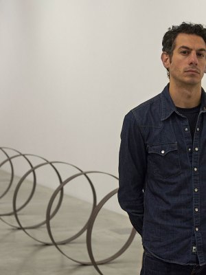 Rayyane Tabet in front of Steel Rings (2013–), from the series The Shortest Distance Between Two Points (2007–).