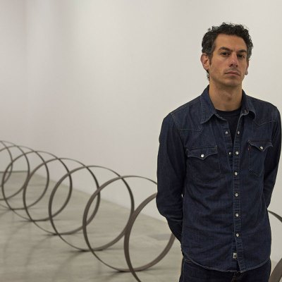 Rayyane Tabet in front of Steel Rings (2013–), from the series The Shortest Distance Between Two Points (2007–).