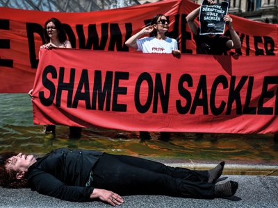 Nan Goldin protesting with P.A.I.N. in the courtyard of the Louvre in July 2019.