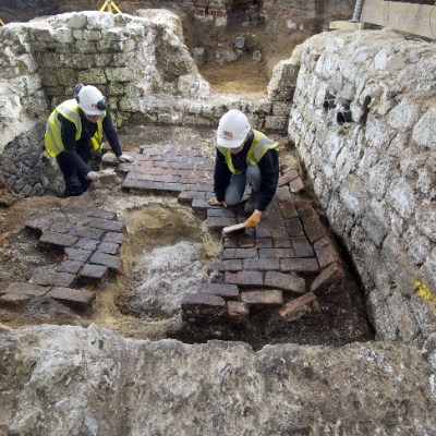 MOLA archaeologists excavate the top of the cesspit.