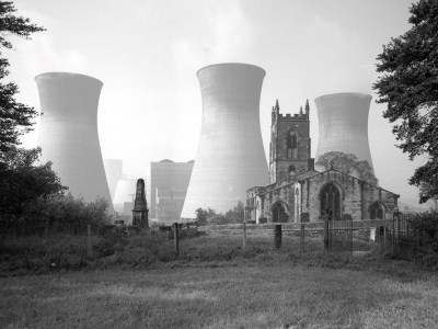 View of Ferrybridge B power station behind the Church of St Edward the Confessor in Brotherton, North Yorkshire, photographed by Eric de Maré in 1960. Photo: © Eric de Maré/RIBA collections