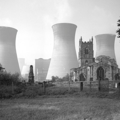 View of Ferrybridge B power station behind the Church of St Edward the Confessor in Brotherton, North Yorkshire, photographed by Eric de Maré in 1960. Photo: © Eric de Maré/RIBA collections