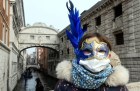A tourist in Venice on 24 February 2020, wearing a protective face-mask and a Carnival mask.
