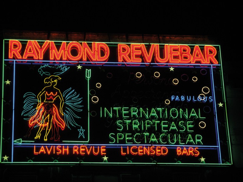 Neon sign made in the 1950s for Raymond Revuebar in Soho, London, photographed in 2015 after restoration and reinstallation.