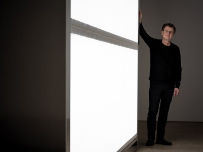 Alfredo Jaar photographed next to his installation ‘The Sound of Silence’ (2006) at Yorkshire Sculpture Park in October 2017. Photo by Jonty Wilde