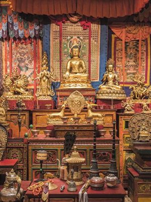 Gilded statues and ritual objects arranged by Alice S. Kandell