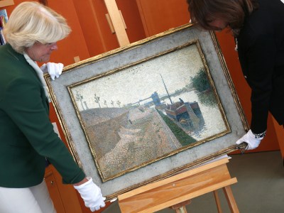 Monika Gruetters (left) hands over the painting ‘Quai de Clichy’ by Paul Signac to Agnes Sevestre-Barbe, representative of the heiress, as part of the return of art stolen under the Nazis and hoarded by Cornelius Gurlitt, the son of Nazi-era dealer Hildebrand Gurlitt in Berlin on July 3, 2019.