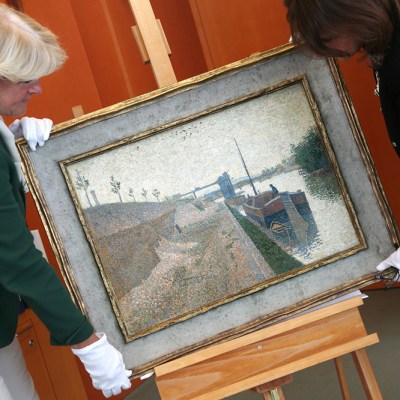 Monika Gruetters (left) hands over the painting ‘Quai de Clichy’ by Paul Signac to Agnes Sevestre-Barbe, representative of the heiress, as part of the return of art stolen under the Nazis and hoarded by Cornelius Gurlitt, the son of Nazi-era dealer Hildebrand Gurlitt in Berlin on July 3, 2019.