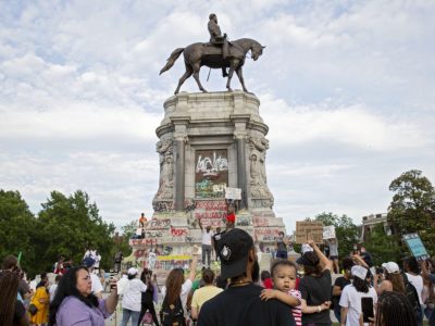 People gather around the Robert E. Lee statue on Monument Avenue in Richmond, Virginia, on June 4, 2020. Earlier, Virginia governor Ralph Northam announced plans to remove the statue of the Confederate general. Photo: Ryan M. Kelly/AFP via Getty Images