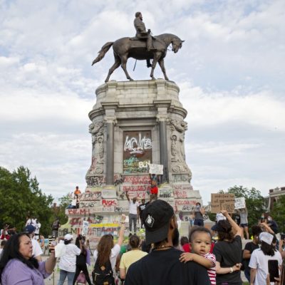 People gather around the Robert E. Lee statue on Monument Avenue in Richmond, Virginia, on June 4, 2020. Earlier, Virginia governor Ralph Northam announced plans to remove the statue of the Confederate general. Photo: Ryan M. Kelly/AFP via Getty Images