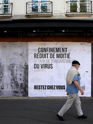 Pasted photographs by Gaia Squarci (Prospekt), and Ashely Gilbertson (VII) on Boulevard des Filles du Calvaire, Paris, 2020.