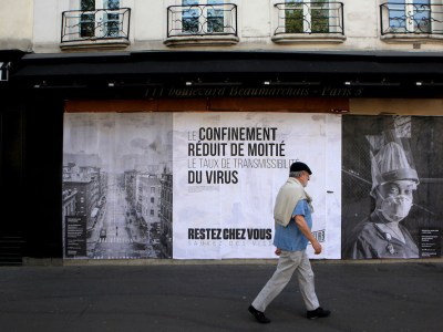 Pasted photographs by Gaia Squarci (Prospekt), and Ashely Gilbertson (VII) on Boulevard des Filles du Calvaire, Paris, 2020.